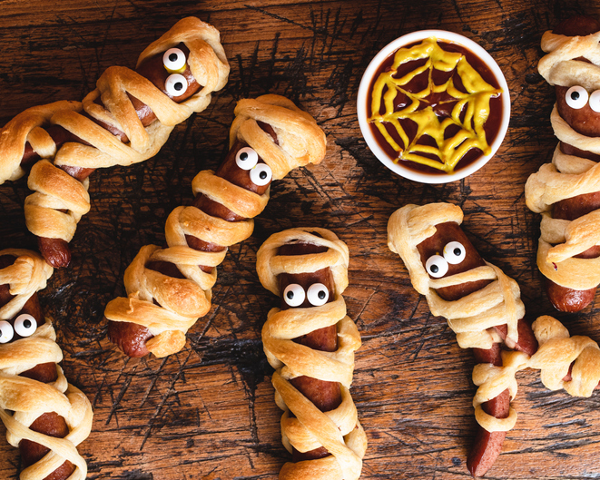 Hotdogs wrapped in crescent rolls designed to look like mummies. with eyes